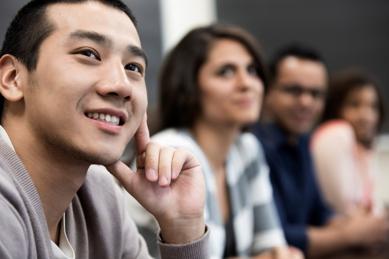 a diverse group of individuals listening intently during a training session